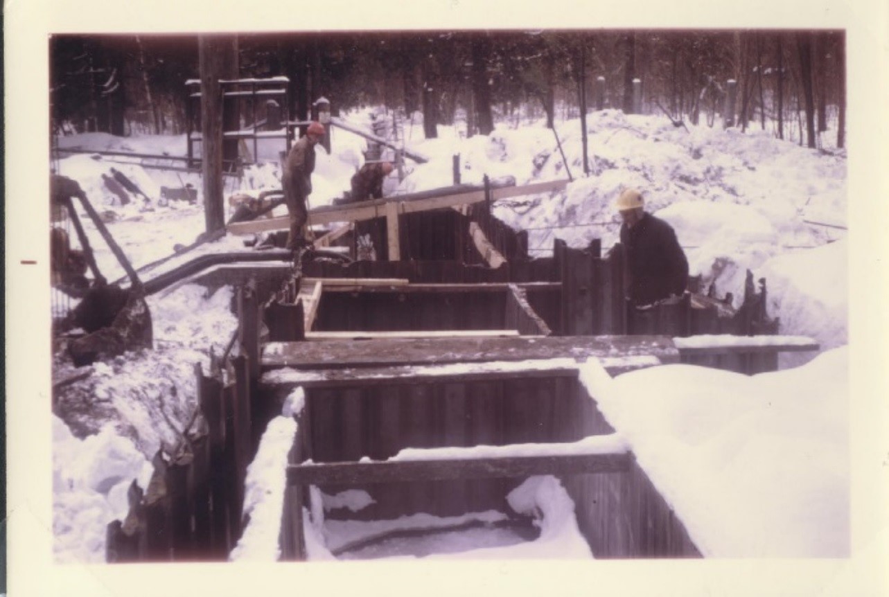 historical photo of men working on a trough