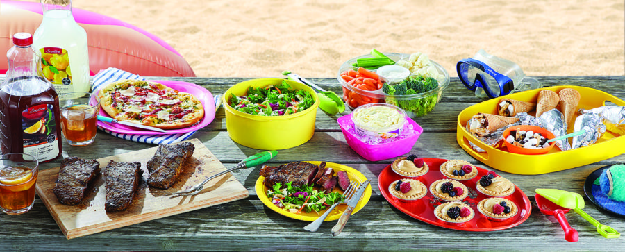 picnic spread over a picnic table on the beach