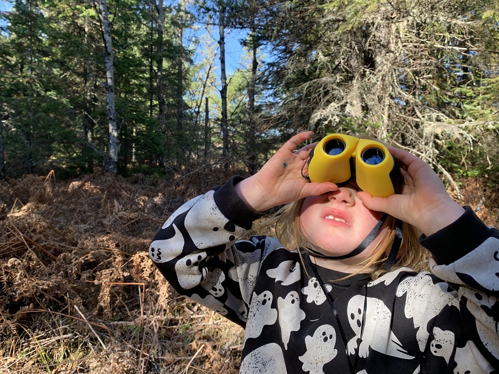Child birding with binocular,