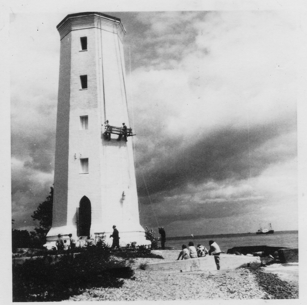 black and white image of lighthouse being repainted