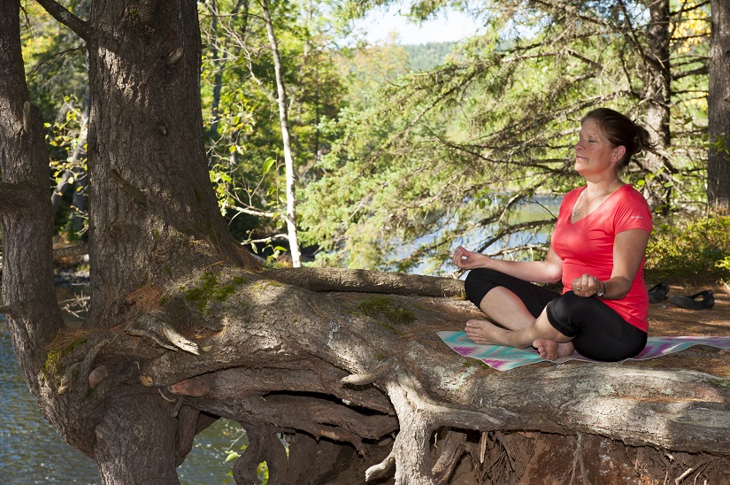 Woman meditates outdoors
