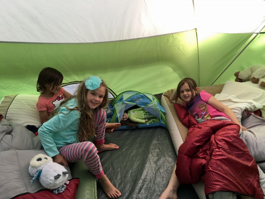 girls in tent with doll