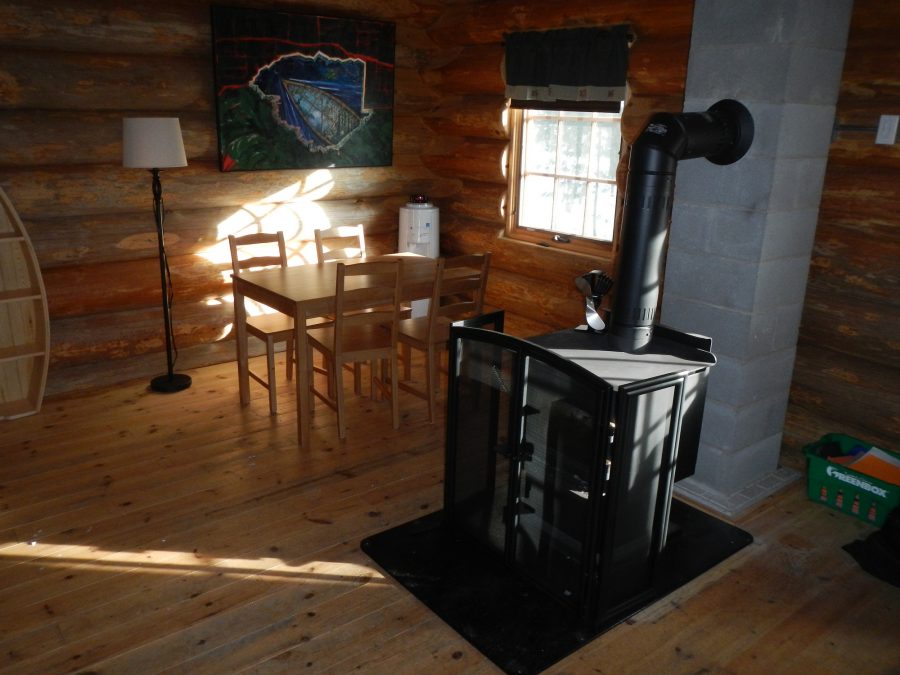 quetico cabin inside. stove, kitchen table window.