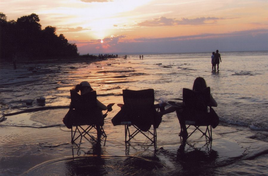3 chairs on beach at sunset