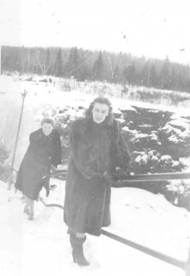 women beside snowy falls