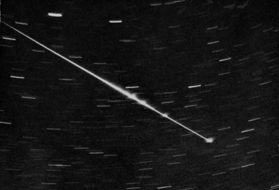 Black and white shot of a meteor in the sky