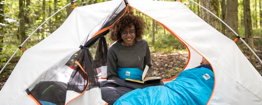 woman in tent with book