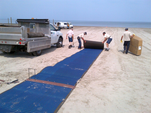 Beach mats being rolled out onto the beach at Wasaga Beach. 