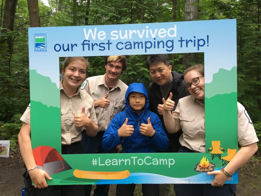 Group of leaders and campers in Learn to Camp photo frame. 