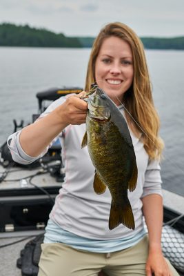 Ashley holds up a bass