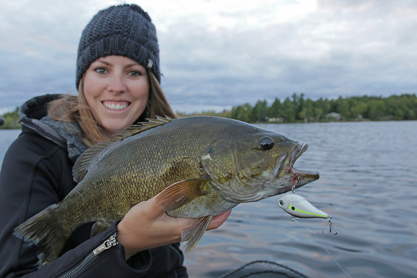 Ashley holds up a smallmouth bass