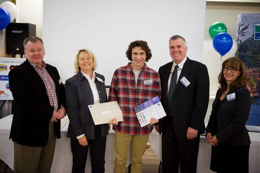 student receiving bursary from park staff and partners