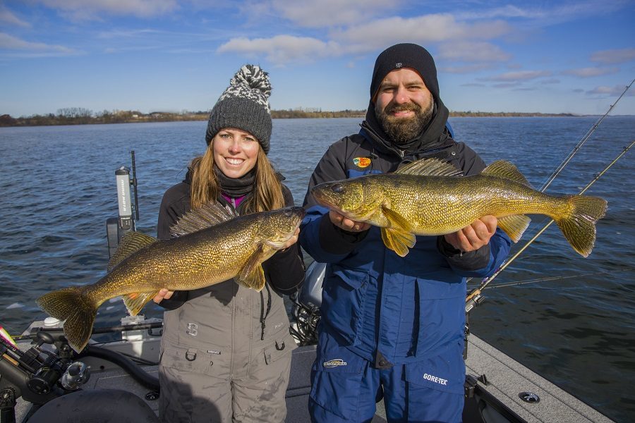 Man and woman hold two walleye