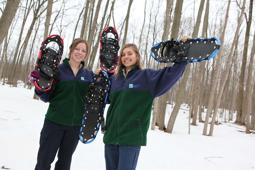 Staff holding up snowshoes.