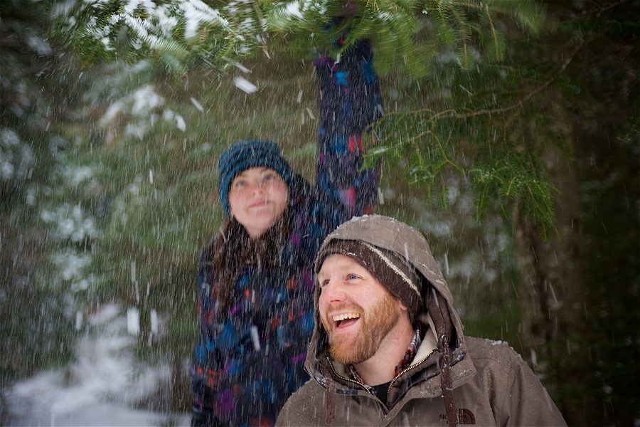 Man and woman play in snow