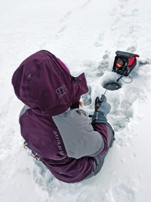 Person sits on ice with sonar