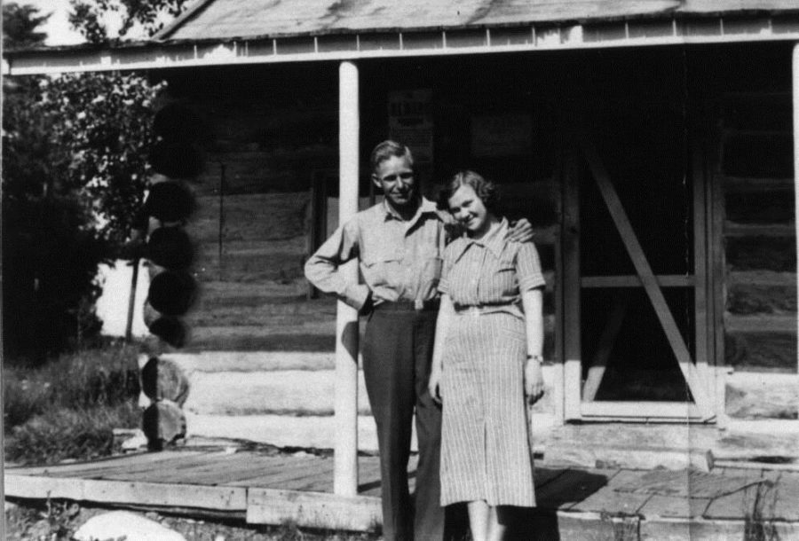 Jess and Kay Valley stand in front of a cabin