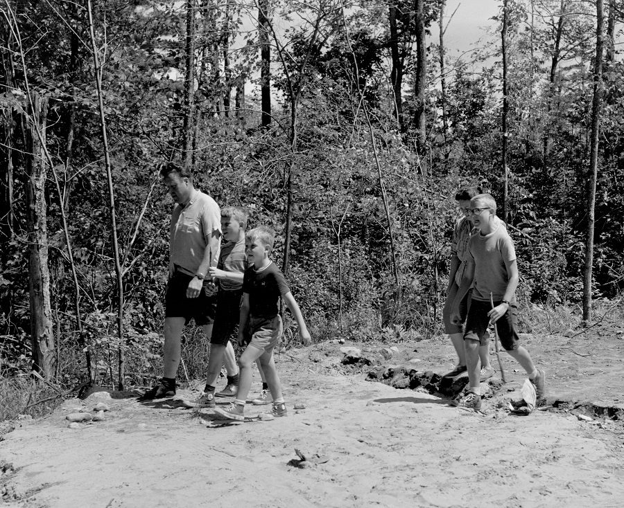 Black and white photo of campers walking