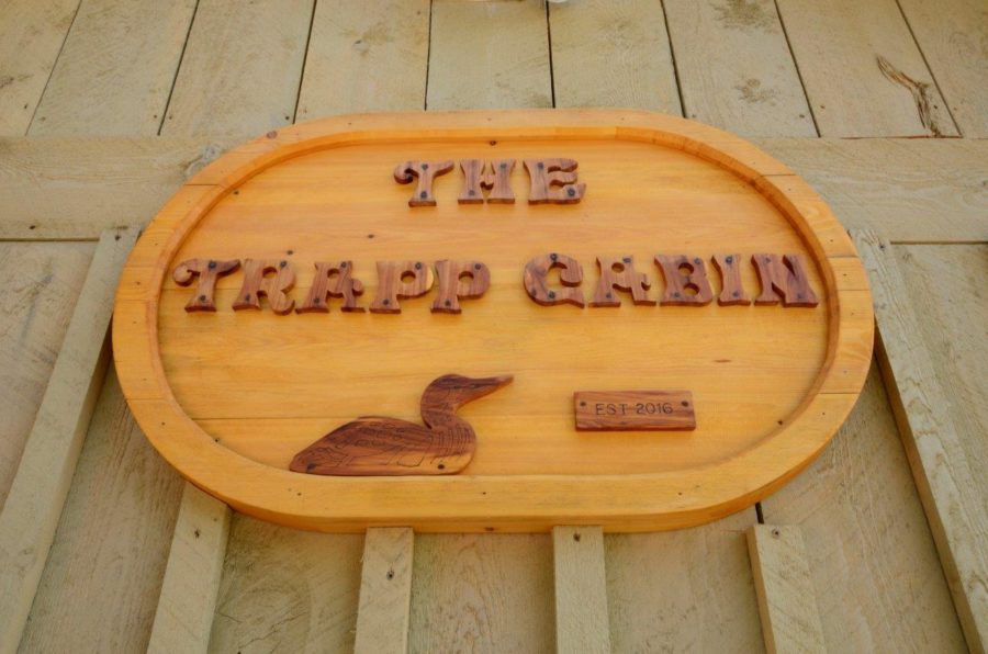 wooden sign on cabin: "Trapp Cabin"