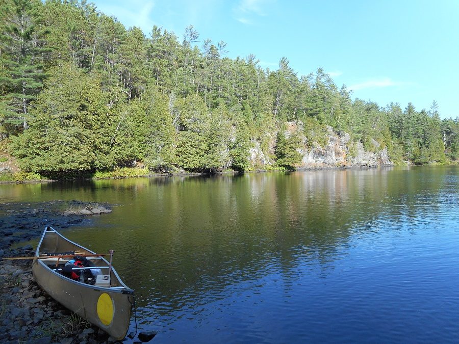 Canoe sits lakeside