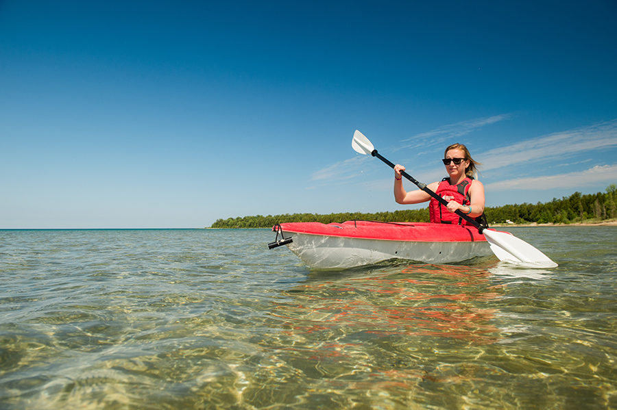 Woman kayaking in clear water