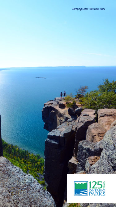 Two people looking out over Lake Superior from tall cliff at Sleeping Giant Provincial Park