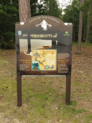 Interpretive sign that says "Path of the Paddle. Quetico Trail..."