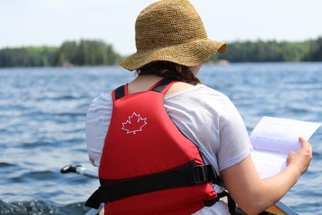 woman in canoe looking at map