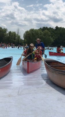 Canoe with kids in it, backing out into the pool