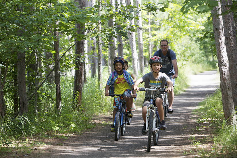 Kids biking on trail in forest