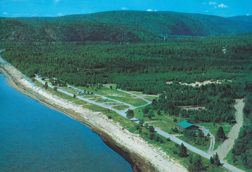 Shoreline with campground very close and forest with hills in the background