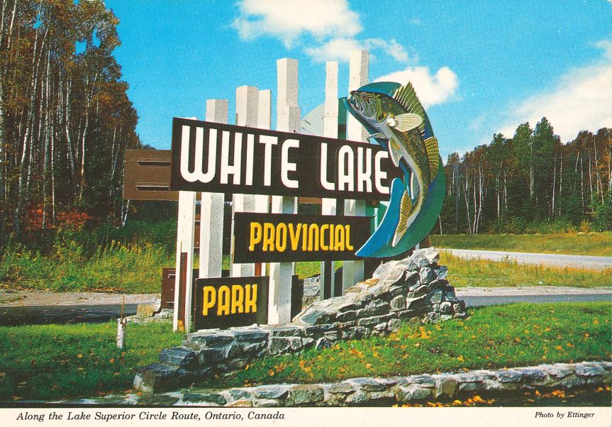 Panneau à l’entrée du parc indiquant « parc provincial White Lake » avec un grand poisson doré jaune à côté 