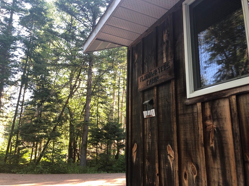 outside of wooden cabin with sign