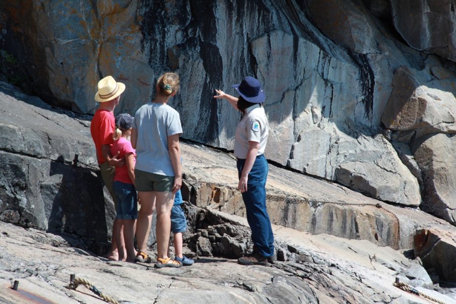 Staff member showing visitors pictographs on the rocks