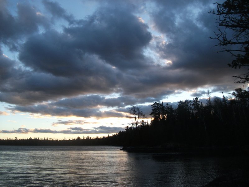 Cloudy skies over a lake at dusk