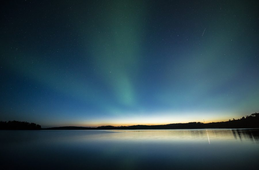 Lake at dark with northern lights in the sky