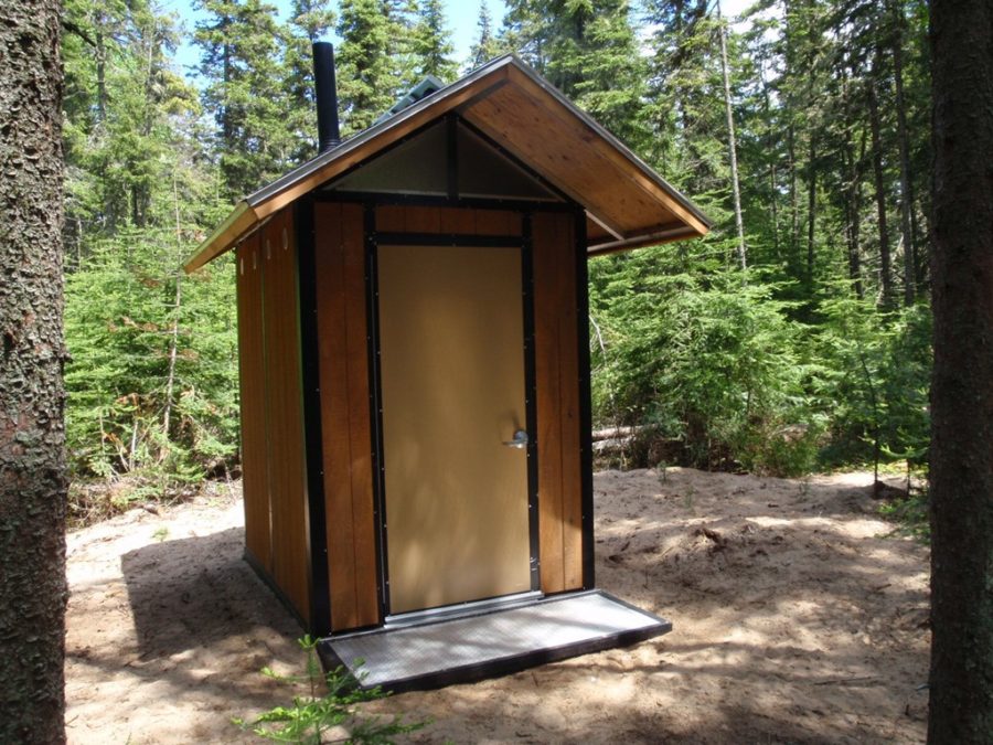 Une toilette extérieure à compostage dans le bois