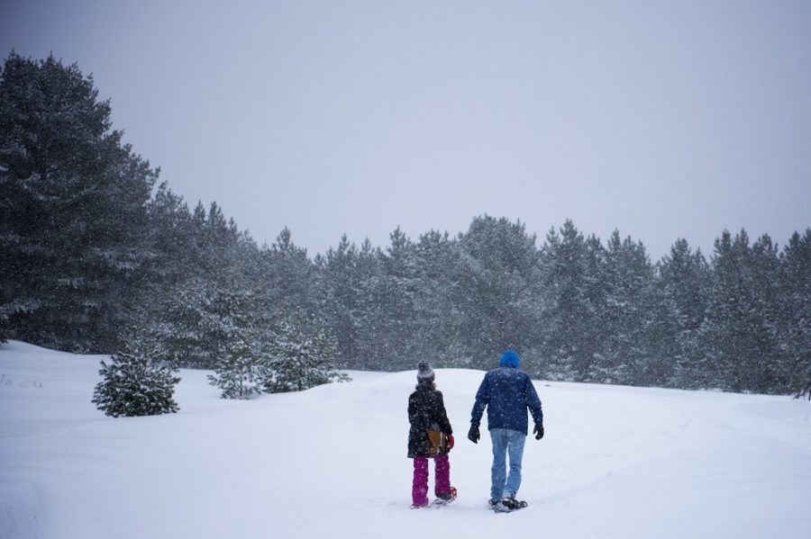 Couple snowshoeing in a blizzard