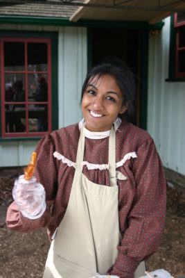 woman in costume holdingt taffy