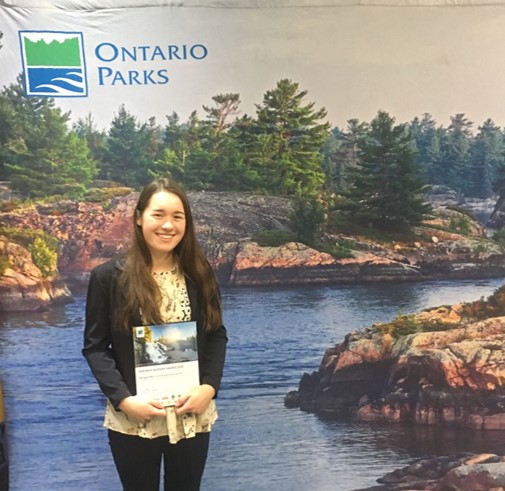woman standing in front of Ontario Parks backdrop