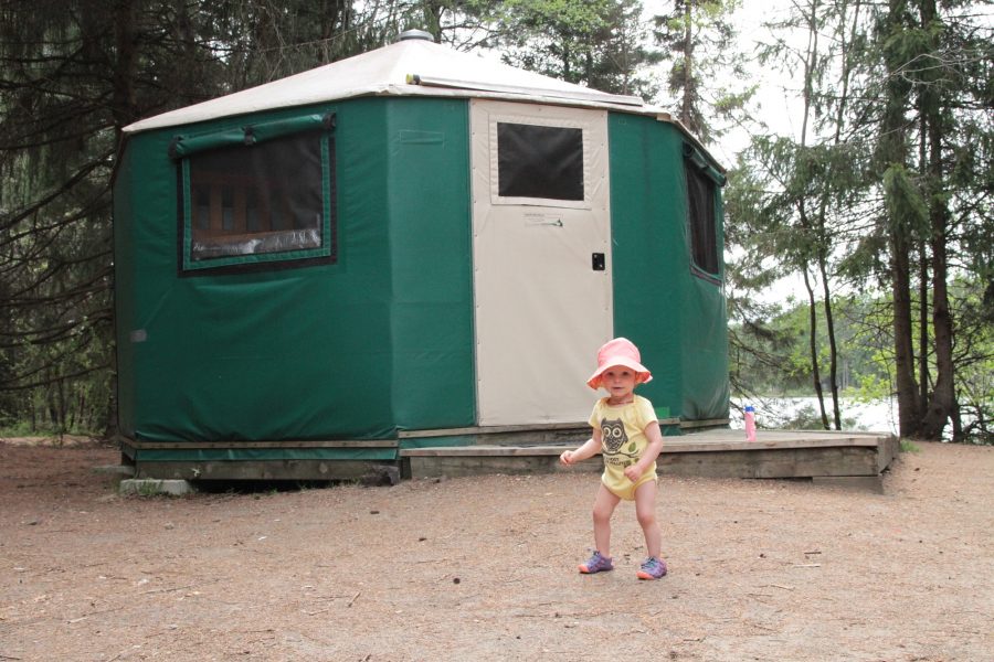 baby in front of yurt