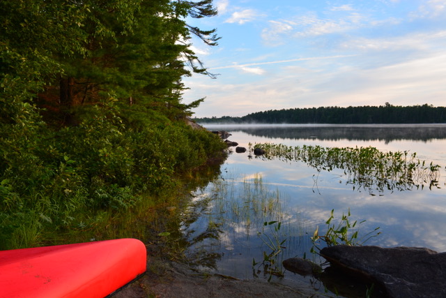 lake with docked canoe