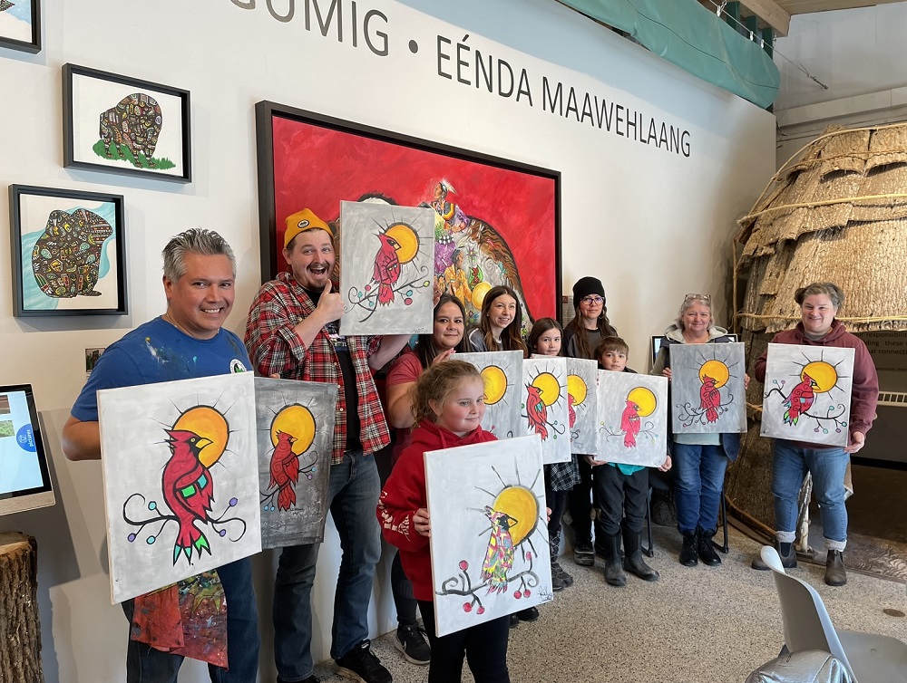 group holding paintings