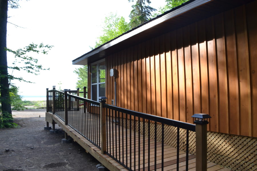 Side view of camp cabin shows the accessible ramp attached to the building.