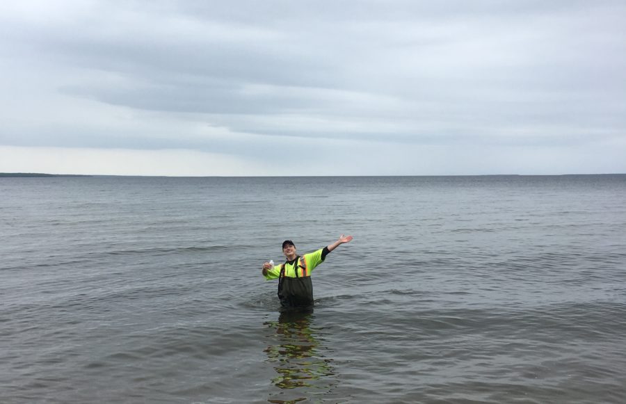 ranger standing in Lake Superior