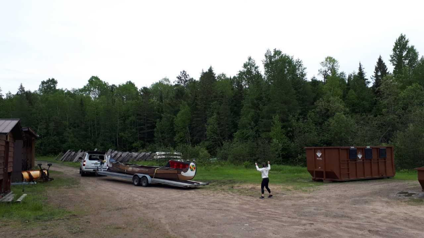 Reversing the trailer holding the canoe in between two bins in the maintenance yard.
