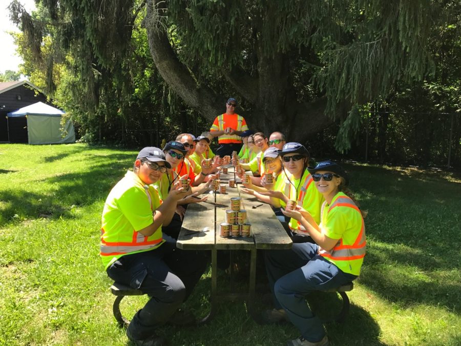 staff at picnic table eating beans