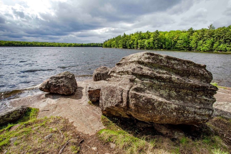 A glacial erratic, a massive boulder left behind thousands of years ago by glacial ice, lies on the shore of Hardy Lake