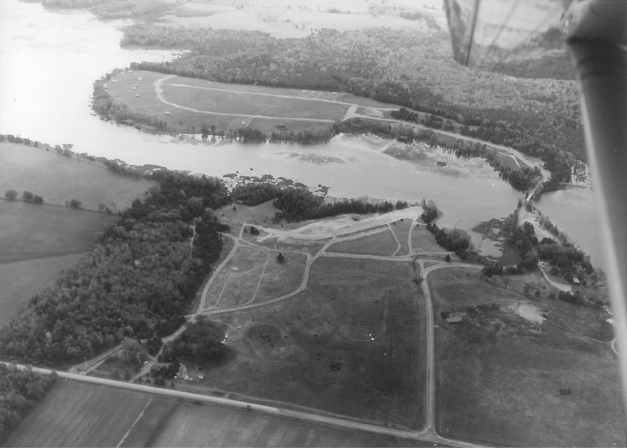 A historical picture of a aerial photo of Emily Provincial Park and the lot across the river that is now Cowan's Bay.