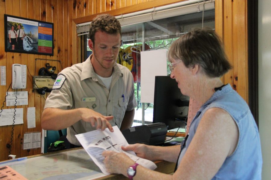 gate staff showing map to camper
